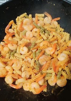 A picture of Shrimp and noodles with garlic sauce.