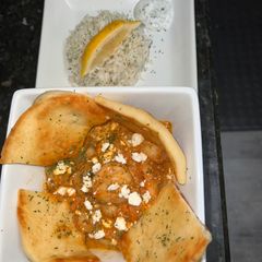 A picture of Greek Shrimp in a Spicy tomato sauce.