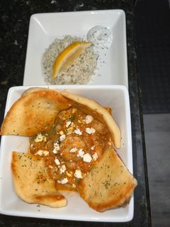 A picture of Greek Shrimp in a Spicy tomato sauce.