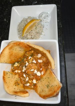 A picture of Greek Shrimp in a Spicy tomato sauce.