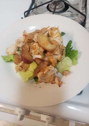 A picture of Chicken breast on a bed of sauted apples and onions.