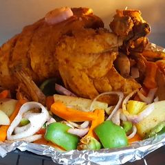 A picture of Steam chargha with vegetables sizzling.