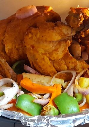 A picture of Steam chargha with vegetables sizzling.