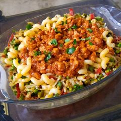 A picture of Pasta with red chicken sauce and vegetables.