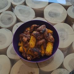 A picture of Braaied wings and sweetcorn.