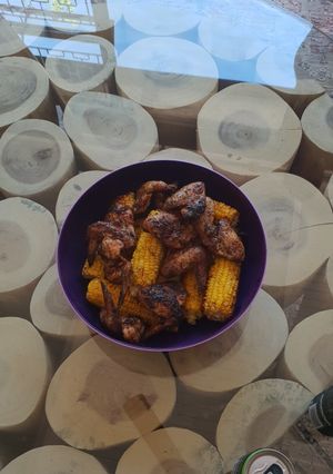 A picture of Braaied wings and sweetcorn.