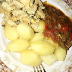 A picture of Boiled potatoes with sauce... garnished with scrambled egg 🍳.
