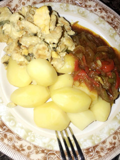 A picture of Boiled potatoes with sauce... garnished with scrambled egg 🍳.