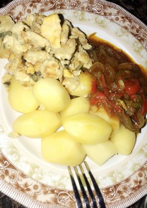 A picture of Boiled potatoes with sauce... garnished with scrambled egg 🍳.