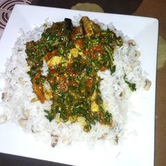 A picture of Rice and beans with spinach stew.