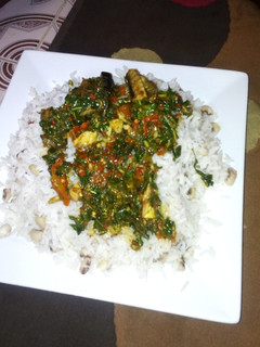 A picture of Rice and beans with spinach stew.
