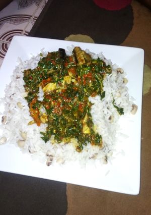 A picture of Rice and beans with spinach stew.