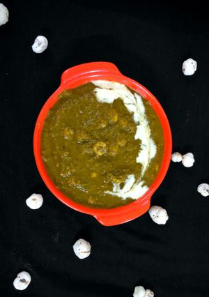 A picture of Makhana lotus seeds with potato in Spinach greavy.