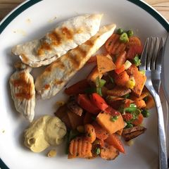 A picture of Grilled chicken with fried sweet potato and veggies.