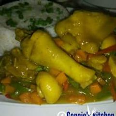 A picture of White rice with chicken vegetable sauce.
