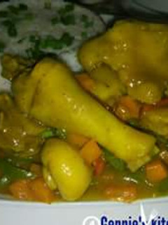 A picture of White rice with chicken vegetable sauce.