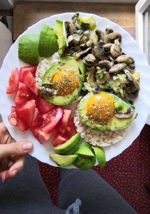 A picture of Eggs in avo with mushrooms and onion.