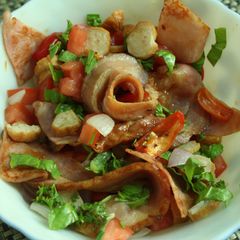 A picture of Bacon, Ham and sausages with onions and habanero peppers in honey and fresh herbs.