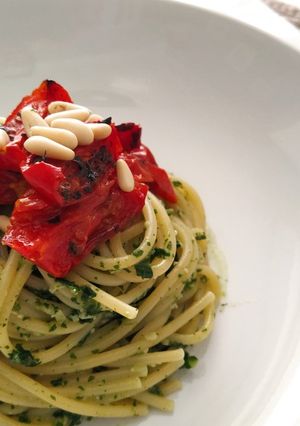 A picture of Spaghetti with Dandelion and Almond Pesto with Roasted Cherry Tomatoes.
