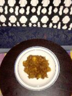 A picture of Beans Jollof with sweet potatoes and smoke fish.
