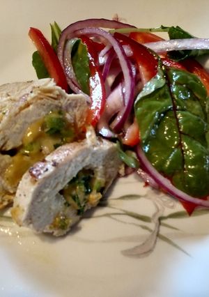 A picture of Stuffed Chicken Breasts with salad.