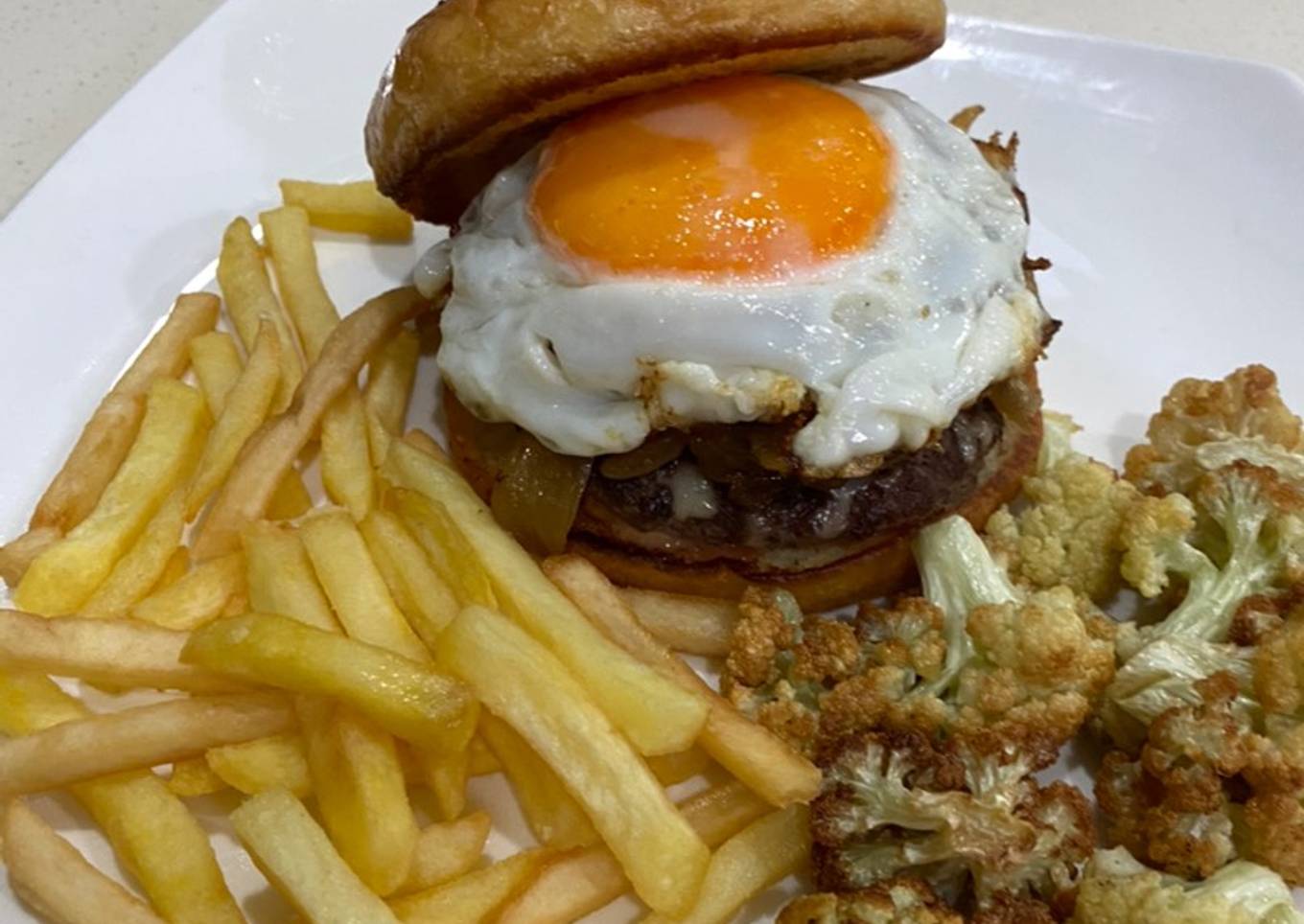 Cheese burger with caramelized onion and egg