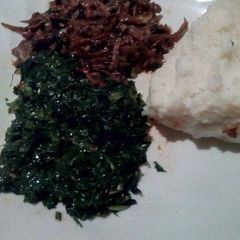 A picture of Fried omena served with sukuma and ugali.