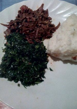 A picture of Fried omena served with sukuma and ugali.