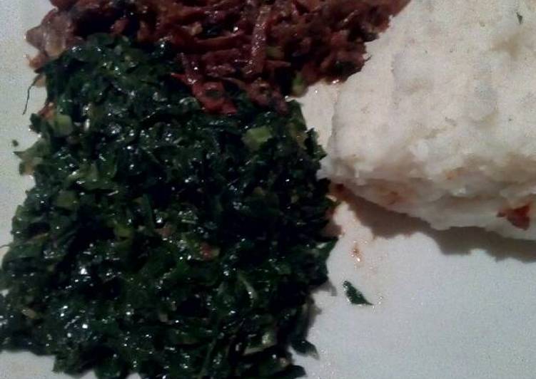 Fried omena served with sukuma and ugali