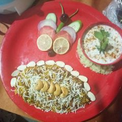 Biryani & veg raita A picture of Biryani & veg raita.
