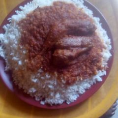 A picture of White rice with stew and fish.