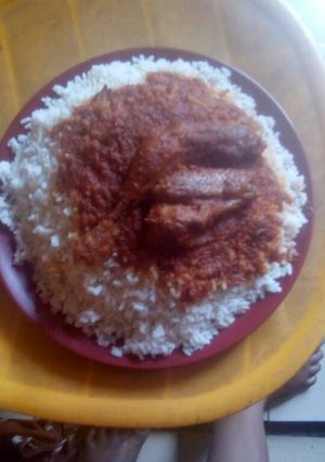 A picture of White rice with stew and fish.