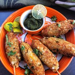 A picture of Sago veggies skewers with mint coriander sauce.