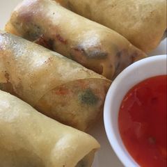 A picture of Springroll with sweet and chilli sauce.