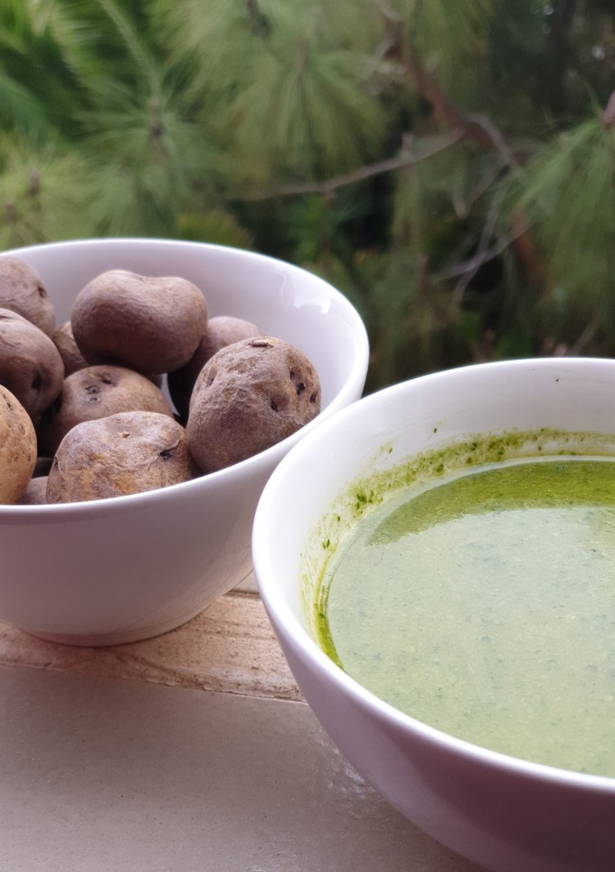 Una foto de Papas negras con mojo verde de cilantro