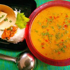 A picture of Oats and orange rasam.