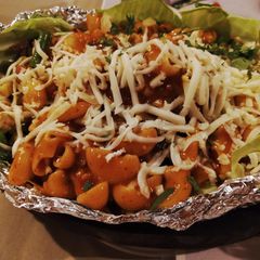A picture of Sizzling pasta in red sauce.