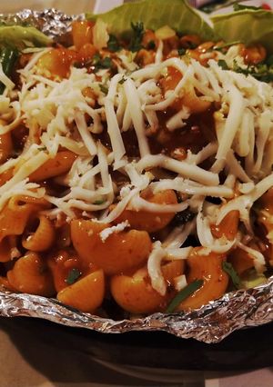 A picture of Sizzling pasta in red sauce.