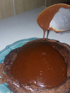 A picture of Chocolate pancakes topped with homemade chocolate sauce.