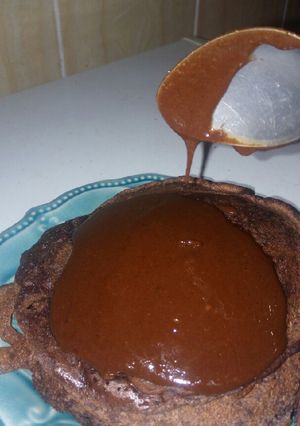 A picture of Chocolate pancakes topped with homemade chocolate sauce.