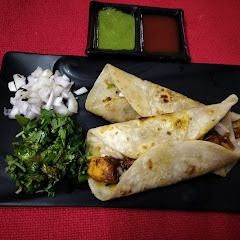 A picture of Leftover chicken tikka kathi roll.