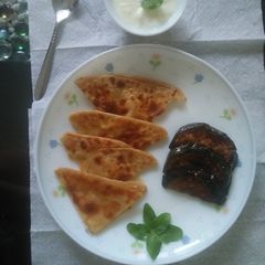 A picture of Fried Brinjal with parantha &curd.