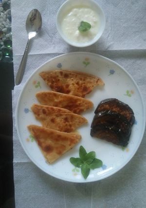 A picture of Fried Brinjal with parantha &curd.