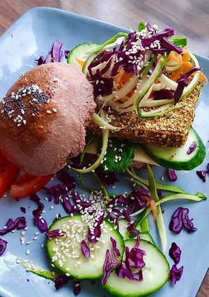 Una foto de Hamburguesa vegana de tofu rebozado en especias con pan de remolacha