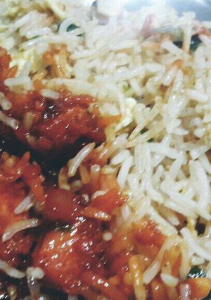 A picture of Fried rice with orange chicken.