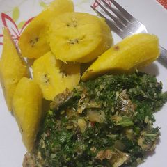 A picture of Boiled semi riped plantain with ugu sauce.