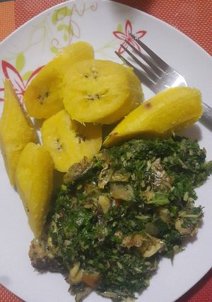 A picture of Boiled semi riped plantain with ugu sauce.