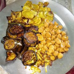 A picture of Fried vegetables and dumplings.