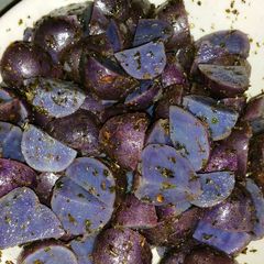 A picture of Purple Potatoes with Garlic, Herbs, and Parsley.