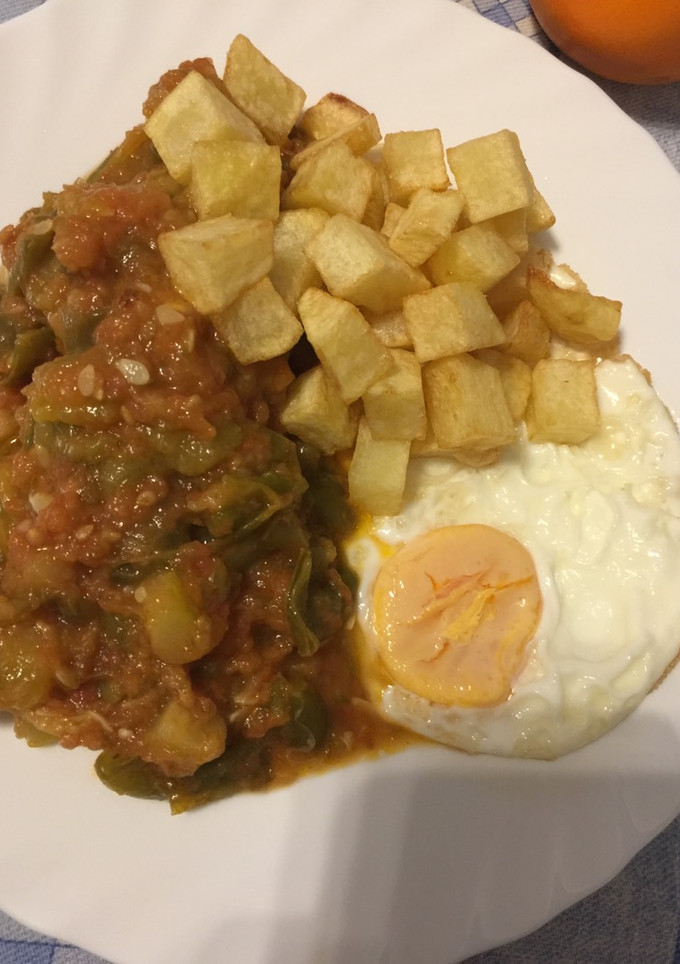 Una foto de Pisto pimiento y calabacín con huevo y patatas fritas